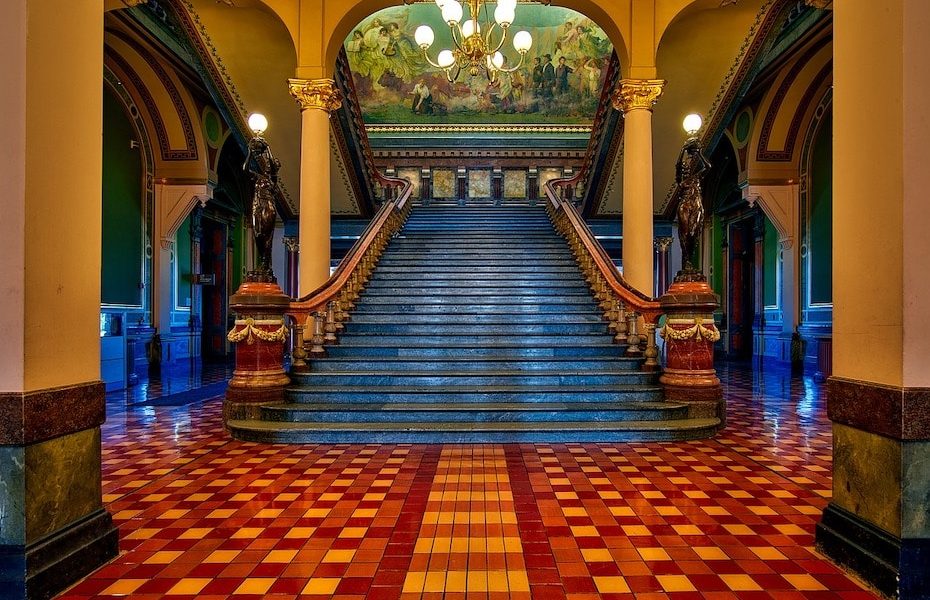 An impressive entrance and grand staircase within a government building
