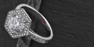 A diamond ring on a dark gray background.