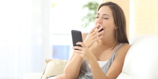 shutterstock_woman_yawning_at_smartphone.jpg