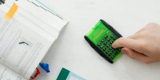 Person Using A Green and Black Calculator