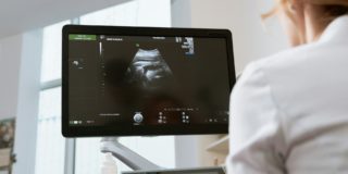 Photo Of An OB-GYN Looking In The Monitor