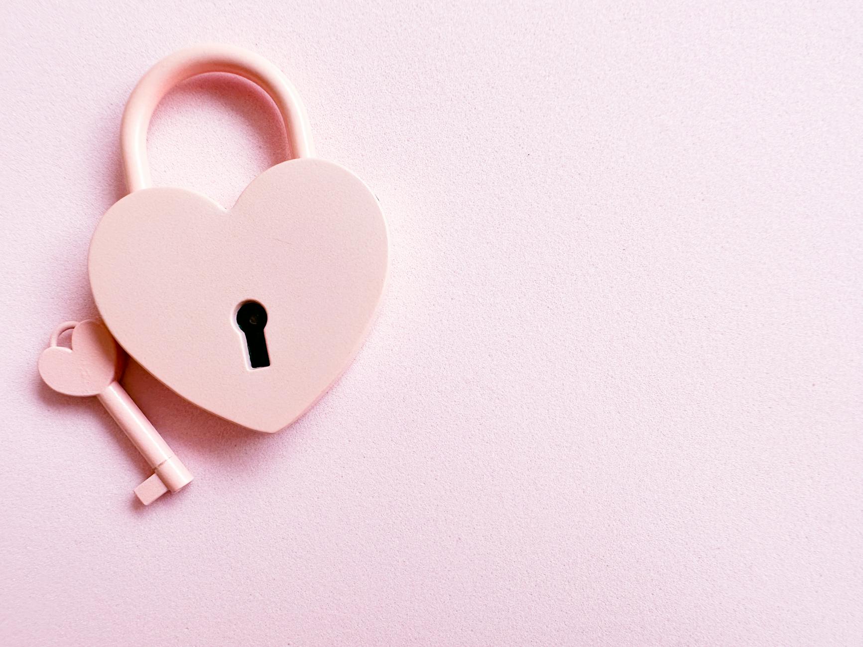 Photo of a Pink Heart Shaped Padlock and a Key