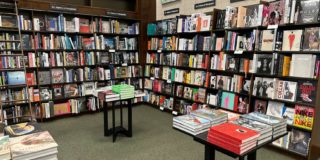 A bookstore with books on the shelves and tables